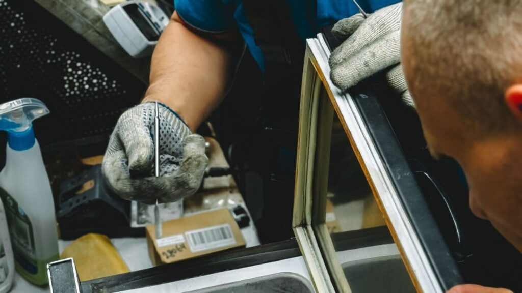 Technician repairing a refrigerator